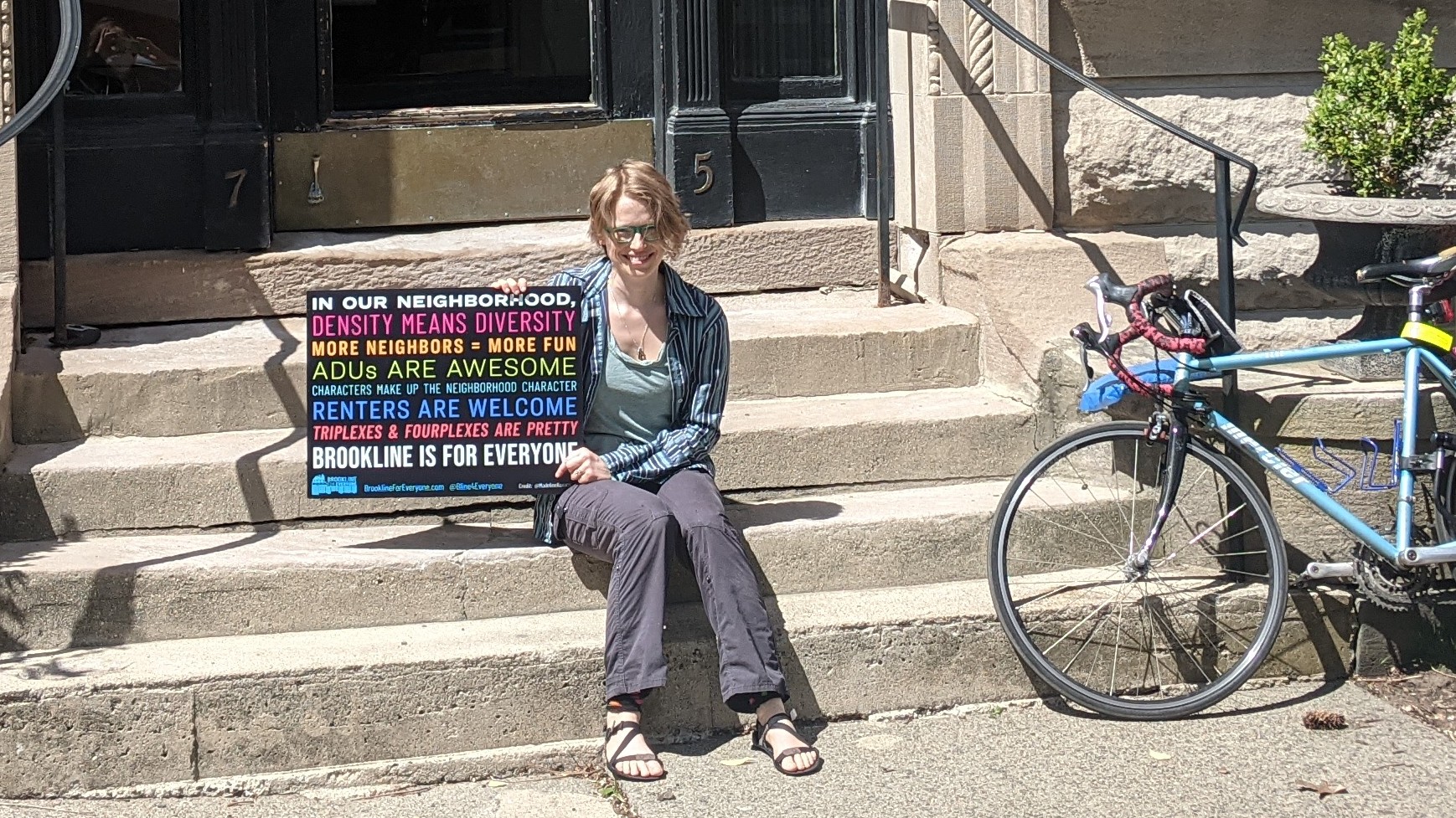 Me on my front porch with a Brookline for Everyone sign and my
bicycle